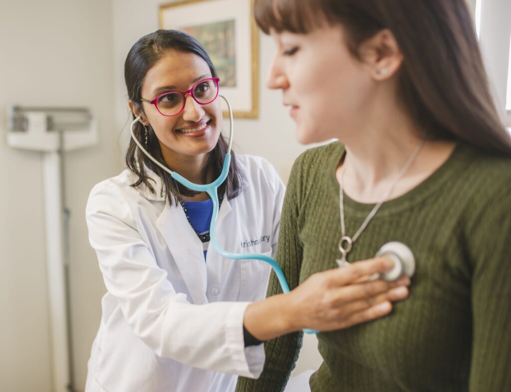 provider checking patient lungs